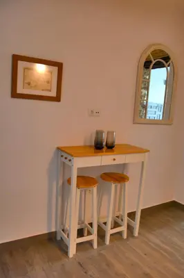 a small table with two stools in a room at Alojamientos Plaza de España in Medina Sidonia