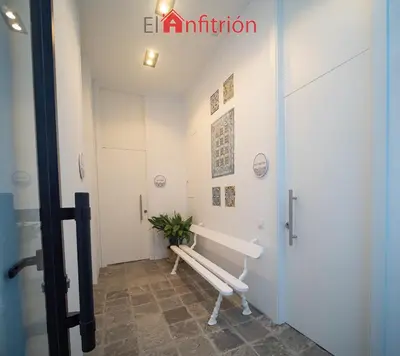 a hallway with a bench in a room at Bodega Mar - Manzanilla in Sanlúcar de Barrameda