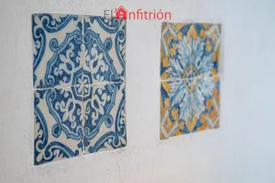 two blue and white tiles on a wall at Bodega Mar - Manzanilla in Sanlúcar de Barrameda
