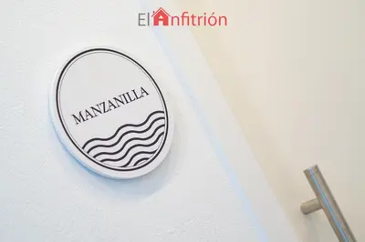 a mirror on a wall with a sign on it at Bodega Mar - Manzanilla in Sanlúcar de Barrameda