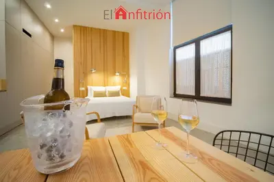 a bottle of wine and two glasses on a table at Bodega Mar - Manzanilla in Sanlúcar de Barrameda