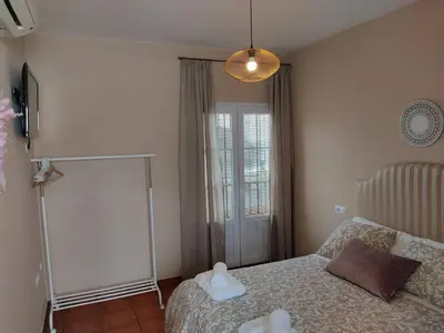a bedroom with a bed with two stuffed animals on it at ALOJAMIENTO La CAPILLITA HABITACION CON BAÑO in Sanlúcar de Barrameda