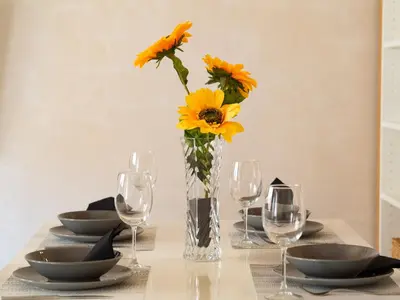 a table with a vase with sunflowers in it at Sunflowers in Sanlúcar de Barrameda