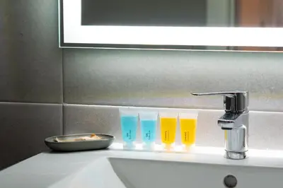 three glasses sitting on top of a bathroom sink at Sunflowers in Sanlúcar de Barrameda