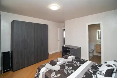 a bedroom with a bed and a large closet at Sunflowers in Sanlúcar de Barrameda