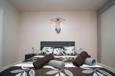 a bedroom with a large bed with pillows on it at Sunflowers in Sanlúcar de Barrameda