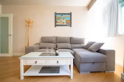 a living room with a couch and a table at Sunflowers in Sanlúcar de Barrameda