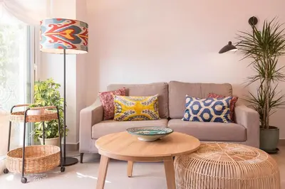 a living room with a couch and a table at Sol de Sanlúcar Ático centro Parking incluido in Sanlúcar de Barrameda