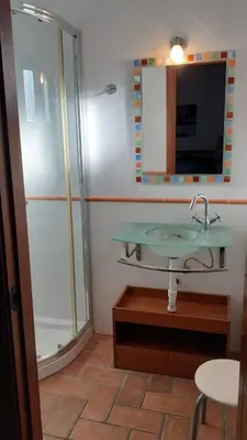 a bathroom with a glass sink and a shower at Chalet Zorollo con piscina in Conil de la Frontera
