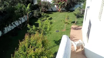 a view of a yard from the balcony of a house at Chalet Zorollo con piscina in Conil de la Frontera