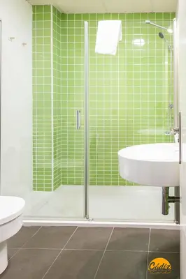 a green tiled bathroom with a tub and a sink at Rincon del Mar - FREE PARKING by Cadiz Time in Cádiz