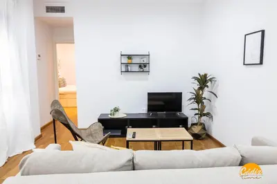 a living room with a couch and a table at Rincon del Mar - FREE PARKING by Cadiz Time in Cádiz