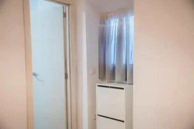 a room with a window and a white refrigerator at Apartamento Me'ncanta Jeré in Jerez de la Frontera