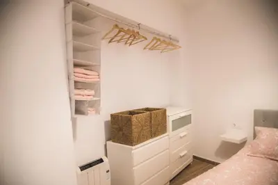 a small bedroom with a bed and a closet at Apartamento Me'ncanta Jeré in Jerez de la Frontera