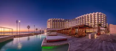 a hotel with a swimming pool in front of a building at Cádiz Bahía by QHotels in Cádiz