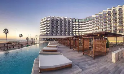 a hotel with a swimming pool in front of a building at Cádiz Bahía by QHotels in Cádiz