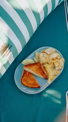a blue plate of food with chips and toast at Cádiz Bahía by QHotels in Cádiz
