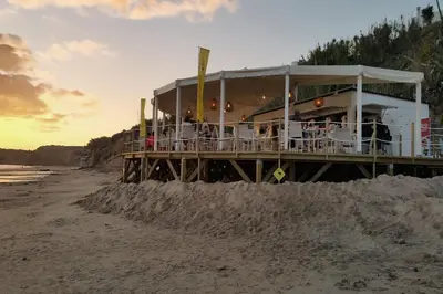 a restaurant on a pier on the beach at Casa Levante en playa Fuente del Gallo in Conil de la Frontera