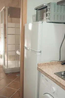 a white refrigerator in a kitchen with a counter at Apartamento Doña Lola in Jerez de la Frontera