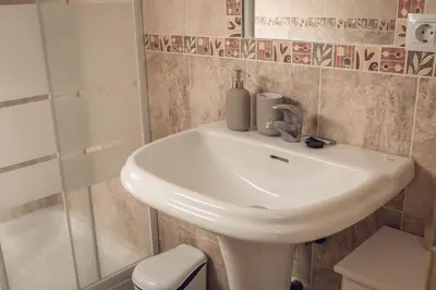 a bathroom with a white sink and a shower at Apartamento Doña Lola in Jerez de la Frontera