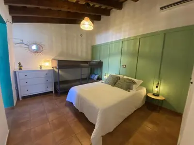 a bedroom with a white bed and green cabinets at SUMATRA in Chiclana de la Frontera