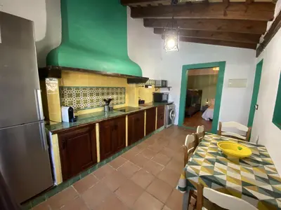 a kitchen with a table and a green ceiling at SUMATRA in Chiclana de la Frontera