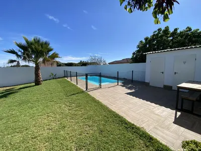 a backyard with a swimming pool and a fence at SUMATRA in Chiclana de la Frontera