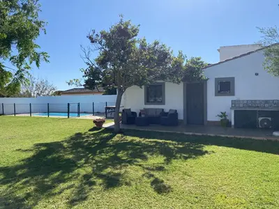 a house with a tree in a yard at SUMATRA in Chiclana de la Frontera