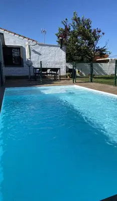 a large blue swimming pool in front of a house at SUMATRA in Chiclana de la Frontera