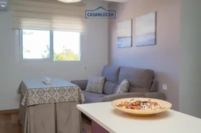 a living room with a couch and a bowl on a counter at Apartamento Aránzazu playa in Sanlúcar de Barrameda
