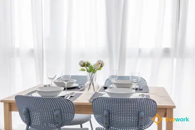 a dining room with a wooden table and chairs at Casa del Pescador by LiveWork in Cádiz