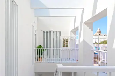 a white balcony with a white table and a window at Genteel Home Mercado Central Terrace in Cádiz