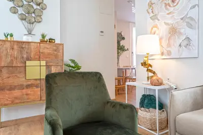 a living room with a chair and a table at Genteel Home Mercado Central Terrace in Cádiz