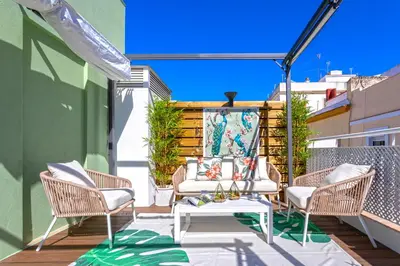 a patio with chairs and a table on a balcony at Genteel Home Mercado Central Terrace in Cádiz