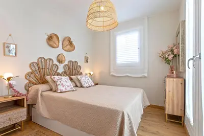 a bedroom with a bed and a window at Genteel Home Mercado Central Terrace in Cádiz