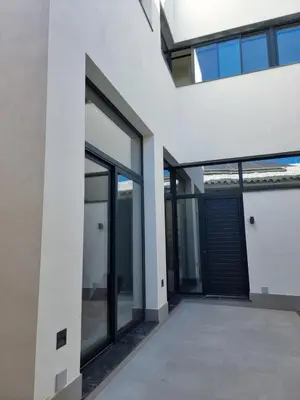 an external view of a building with glass doors at Guesting La Carbona in Jerez de la Frontera