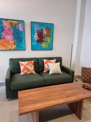 a living room with a green couch and a wooden coffee table at Guesting La Carbona in Jerez de la Frontera