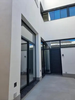 an external view of a building with glass doors at Guesting La Carbona in Jerez de la Frontera