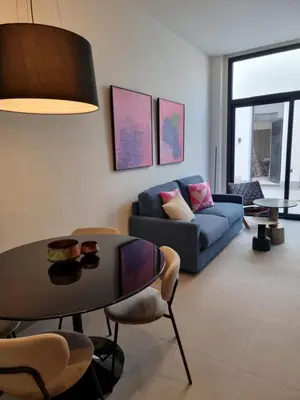 a living room with a table and a couch at Guesting La Carbona in Jerez de la Frontera