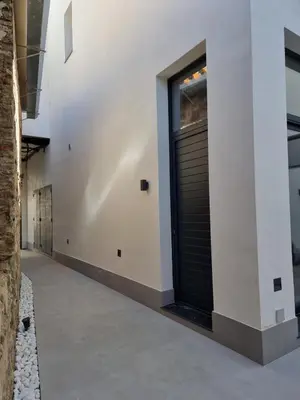 a hallway of a house with a black garage door at Guesting La Carbona in Jerez de la Frontera