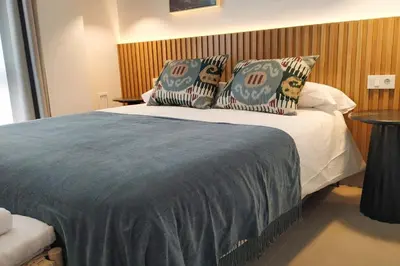 a bedroom with a bed with two pillows on it at Guesting La Carbona in Jerez de la Frontera