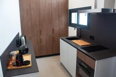 a kitchen with a counter and a stove top oven at Guesting La Carbona in Jerez de la Frontera