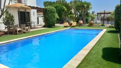 a swimming pool in the yard of a house at Alojamiento El Drago - Sólo Familias y Parejas in Conil de la Frontera