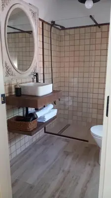 a bathroom with a sink and a mirror at Alojamiento El Drago - Sólo Familias y Parejas in Conil de la Frontera