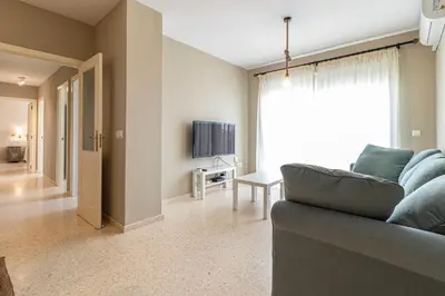 a living room with a couch and a television at Allo Apartments Europa I Parking Piscina Padel 3 Habitaciones in Jerez de la Frontera