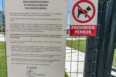 a sign on a fence that says no dogs permitted at Allo Apartments Europa I Parking Piscina Padel 3 Habitaciones in Jerez de la Frontera