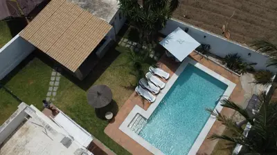 an overhead view of a swimming pool with two lounge chairs at Villa las Raices in Sanlúcar de Barrameda