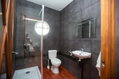 a bathroom with a toilet and a sink at Villa las Raices in Sanlúcar de Barrameda
