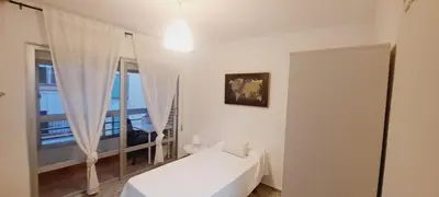 a white bedroom with a bed and a window at Apartamento Soplos de vida in Cádiz