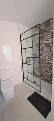 a bathroom with a toilet and a wall with stickers at Apartamento Soplos de vida in Cádiz